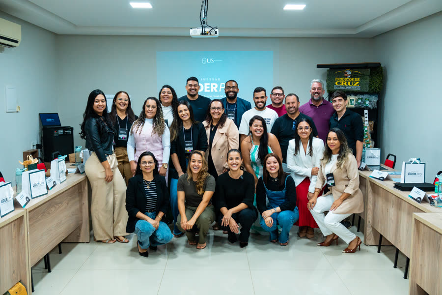Grupo de participantes de uma mentoria de liderança em sala de treinamento